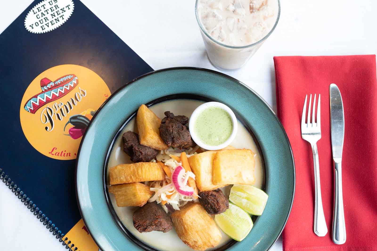 Yuca con chicharrón served beside the Los Primos catering menu